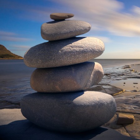 A photo of five rocks stacked on top of each other in a zenful way.